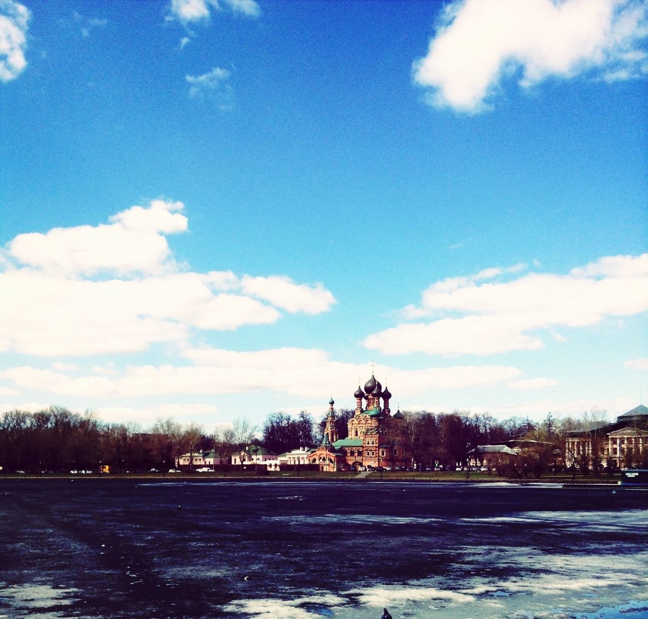 architecture, building exterior, built structure, sky, water, waterfront, cloud - sky, blue, cloud, tree, house, residential structure, river, residential building, nature, outdoors, snow, day, cloudy, no people