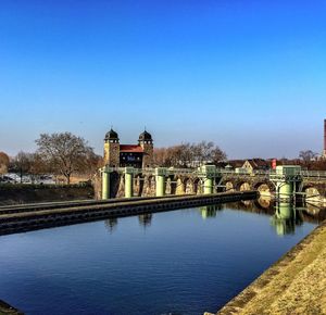 Built structures against clear blue sky