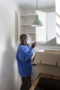 Woman unpacking plates in kitchen