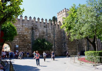 Tourists visiting by historic cathedral against clear sky