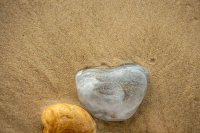 Close-up of heart shape on sand