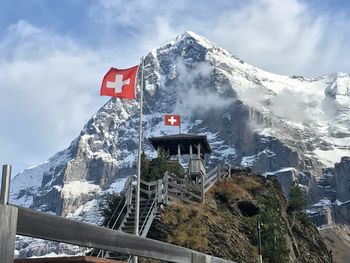 Swiss flags against snowcapped mountains 