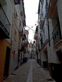 Narrow alley amidst buildings in city