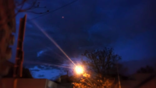 Low angle view of trees against sky at night