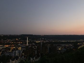 High angle view of illuminated city against sky at sunset