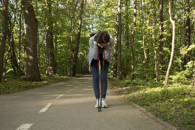 Rear view of woman walking in forest