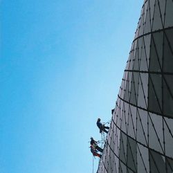 Low angle view of modern building against clear blue sky