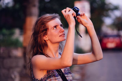 Portrait of woman holding camera