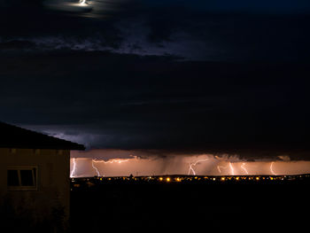 Illuminated building against sky at night