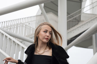 Portrait of young woman looking down in wolken-hain