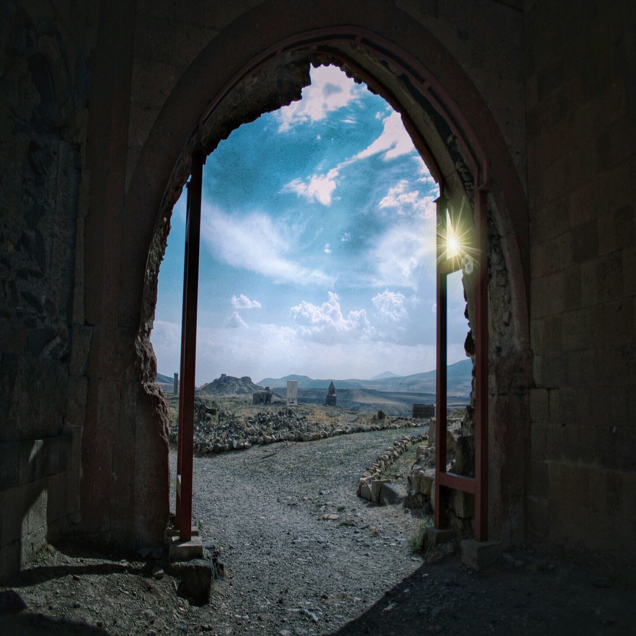 arch, indoors, sky, built structure, cloud - sky, architecture, tranquility, cloud, cloudy, window, sunlight, day, tranquil scene, archway, scenics, nature, old, architectural column, entrance, no people