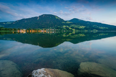 Scenic view of lake and mountains against sky