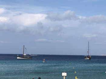 Sailboat sailing on sea against sky