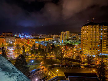 High angle view of city lit up at night