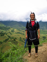 Full length of man standing on mountain against sky