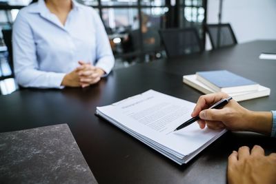 Midsection of doctor working on table