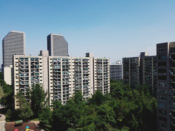 High angle view of modern buildings against clear blue sky