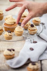 Close-up of hand holding cupcakes