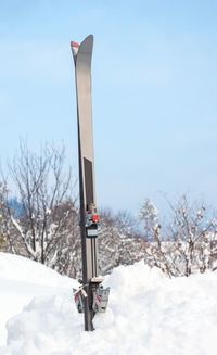 Built structure on snow covered field against sky