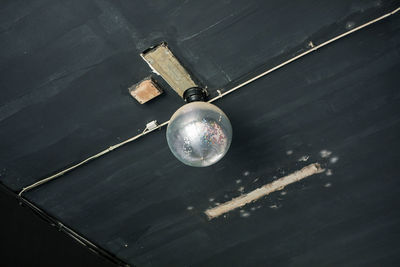 Low angle view of light bulbs hanging from ceiling