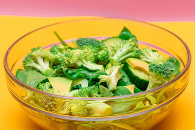 Fresh green salad of avocado, broccoli, spinach and cucumber for body detoxification