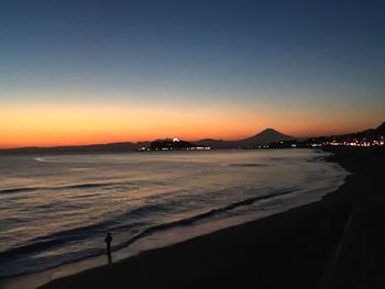 Scenic view of sea against clear sky during sunset