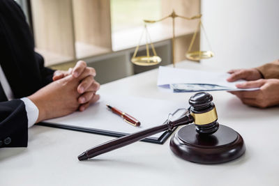 Midsection of lawyer sitting at table