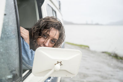 Portrait of teenage girl behind wheel of vintage van