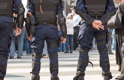 Low section of security guards standing on road in city