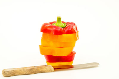 Close-up of multi colored bell peppers against white background