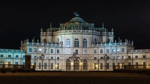 Low angle view of illuminated building against sky at night