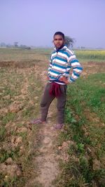 Portrait of boy standing on field