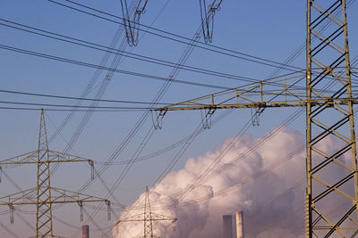 Low angle view of electricity pylon against sky