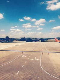 Airplane on runway against sky