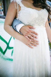 Midsection of couple holding hands