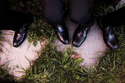 Low section of people standing on grass