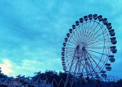 Low angle view of ferris wheel against sky