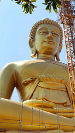 Low angle view of statue against temple against sky