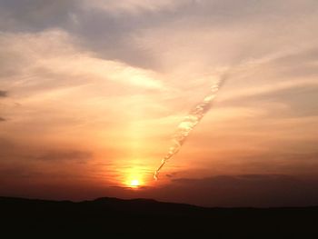 Scenic view of silhouette landscape against romantic sky at sunset