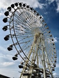 Low angle view of ferris wheel against sky