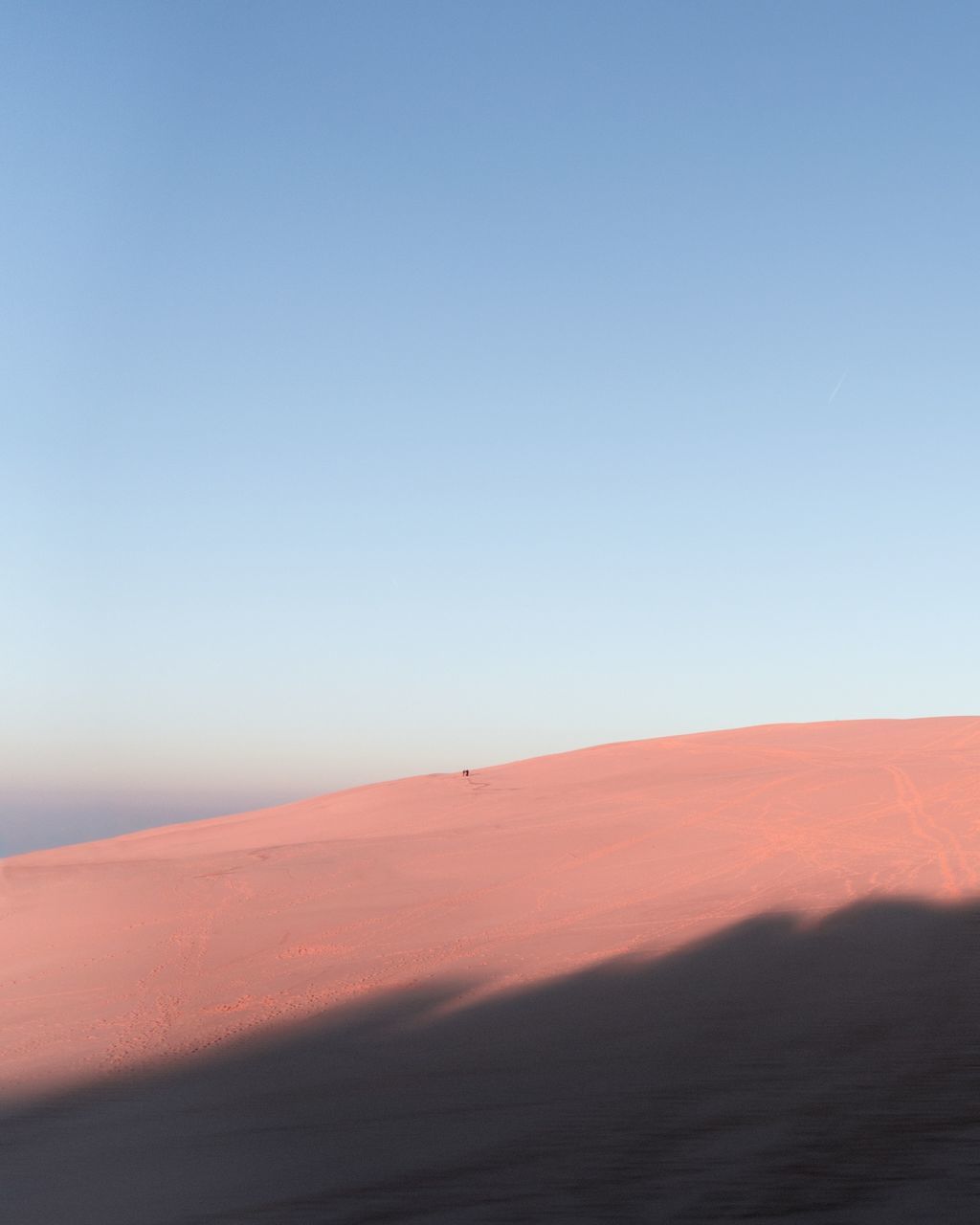 SCENIC VIEW OF DESERT AGAINST CLEAR SKY AT SUNSET