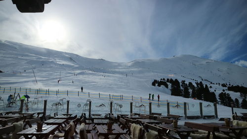 Panoramic view of crowd on snowcapped mountains against sky