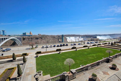 High angle view of bridge over city against blue sky