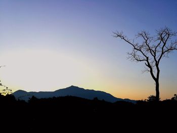 Scenic view of silhouette mountains against sky at sunset