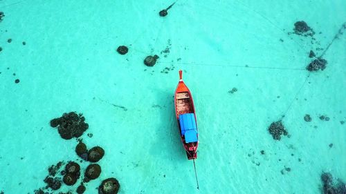 High angle view of boat moored on sea at beach