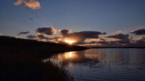 Scenic view of lake against sky during sunset