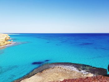 Scenic view of sea against clear blue sky