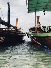 Boats moored in sea against sky