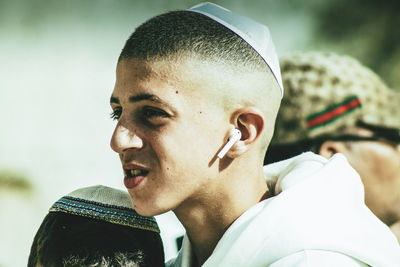 Close-up portrait of young man looking away