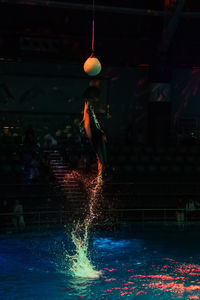 Illuminated lighting equipment in swimming pool at night